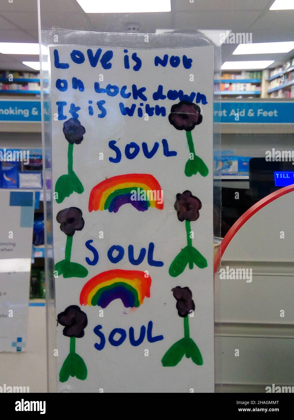 Powerful child`s drawing expressing love and hope during covid pandemic. Colourful rainbows and the words love is not on lock down it is within soul Stock Photo